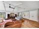 Bright living room featuring stylish decor, a high ceiling, wood floors, and french doors at 1240 Fox Creek Dr, Sarasota, FL 34240
