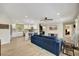 Open-concept living room with a modern kitchen, comfortable seating, and natural light at 1240 Fox Creek Dr, Sarasota, FL 34240