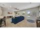 Bright living room with wood floors, comfortable blue sofa, and access to the outdoors through double doors at 1240 Fox Creek Dr, Sarasota, FL 34240
