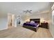 Comfortable main bedroom with en-suite bathroom and featuring wood floors and ceiling fan at 1240 Fox Creek Dr, Sarasota, FL 34240
