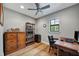 Cozy office space with hardwood flooring, a wooden desk, a bookcase and natural light from a window at 1240 Fox Creek Dr, Sarasota, FL 34240