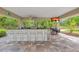 Outdoor bar area with a TV and ample seating, perfect for entertaining and enjoying the beautiful view at 1240 Fox Creek Dr, Sarasota, FL 34240