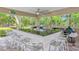Outdoor kitchen and bar area featuring stainless steel appliances, granite countertops, and comfortable seating at 1240 Fox Creek Dr, Sarasota, FL 34240