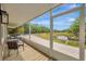 Relaxing screened porch with outdoor seating and a view of the serene pond and landscape at 1240 Fox Creek Dr, Sarasota, FL 34240