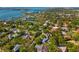 Aerial view showcasing a neighborhood surrounded by lush trees and beautiful waterfront views at 1434 Ladue Ln, Sarasota, FL 34231
