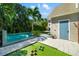 Beautiful backyard featuring a pool, artificial turf, and a vibrant blue entry door at 1434 Ladue Ln, Sarasota, FL 34231