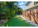 Landscaped backyard with a charming pool, lush green turf, and privacy fence at 1434 Ladue Ln, Sarasota, FL 34231