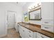 Bathroom with white cabinets, tan marble counters, and a neutral color scheme at 1434 Ladue Ln, Sarasota, FL 34231