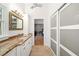 Bathroom with white cabinets and a shower room in the background at 1434 Ladue Ln, Sarasota, FL 34231