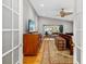 Open view of the bedroom with its ceiling fan, natural lighting, and wooden furnishings at 1434 Ladue Ln, Sarasota, FL 34231