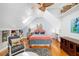 Charming bedroom with vaulted ceiling, built-in shelves, and cozy sitting area at 1434 Ladue Ln, Sarasota, FL 34231