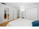 Bright bedroom with white walls and wooden floors, featuring a double closet at 1434 Ladue Ln, Sarasota, FL 34231