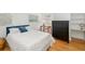 Bright bedroom with wood floors and a simple decor featuring a black dresser at 1434 Ladue Ln, Sarasota, FL 34231