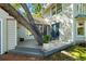 Cozy deck area with seating and a potted plant next to the home's exterior at 1434 Ladue Ln, Sarasota, FL 34231