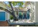 Backyard exterior with a deck and seating area nestled next to an attached blue garage at 1434 Ladue Ln, Sarasota, FL 34231