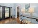 Elegant foyer showcasing a decorative glass front door, hardwood floors, staircase, and view to a modern refrigerator at 1434 Ladue Ln, Sarasota, FL 34231