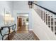 Inviting foyer with hardwood floors, a staircase, and an entry to another room, creating a warm welcome at 1434 Ladue Ln, Sarasota, FL 34231