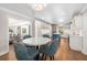 Bright kitchen with white cabinets, blue island, and dining table with upholstered chairs at 1434 Ladue Ln, Sarasota, FL 34231
