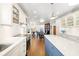 Gourmet kitchen featuring white cabinetry, a center island, hardwood floors, and stainless steel appliances at 1434 Ladue Ln, Sarasota, FL 34231