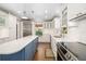 Well-appointed kitchen featuring custom cabinetry, stainless steel appliances, a center island, and hardwood floors at 1434 Ladue Ln, Sarasota, FL 34231