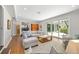 Spacious living room with wood floors, a sectional sofa, and a sliding door to the patio, perfect for entertaining at 1434 Ladue Ln, Sarasota, FL 34231