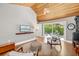 Living room with vaulted wood ceiling and view to back patio at 1434 Ladue Ln, Sarasota, FL 34231