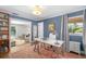 Bright home office with blue walls, open bookcase, light-filled window, and stylish white desk at 1434 Ladue Ln, Sarasota, FL 34231
