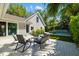 Charming backyard patio with comfortable seating, lush landscaping, and a serene water feature for outdoor relaxation at 1434 Ladue Ln, Sarasota, FL 34231