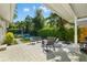 Inviting patio area with comfortable seating, lush landscaping, and a serene water feature for outdoor relaxation at 1434 Ladue Ln, Sarasota, FL 34231