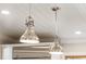 Close-up of pendant lights hanging from a white, shiplap ceiling in the kitchen at 1434 Ladue Ln, Sarasota, FL 34231