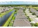 Aerial view showcases the community's beautiful homes, canal, green spaces, and a neighborhood pool at 15612 Trinity Fall Way, Bradenton, FL 34212
