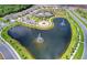 Aerial view features ponds with fountains, a community pool, playground, and well-maintained landscaping at 15612 Trinity Fall Way, Bradenton, FL 34212