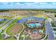 Aerial view showcases the community's pool, playground, scenic ponds with fountains, and meticulously landscaped grounds at 15612 Trinity Fall Way, Bradenton, FL 34212