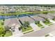 Aerial view of a single-Gathering home near a tranquil pond, surrounded by lush greenery and neighborhood at 15612 Trinity Fall Way, Bradenton, FL 34212