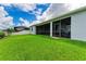 Back of property boasts a screened lanai, well-manicured lawn, and partial fencing for added privacy at 15612 Trinity Fall Way, Bradenton, FL 34212