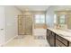 Bathroom featuring tile floors, granite countertops, walk in shower and tub at 15612 Trinity Fall Way, Bradenton, FL 34212