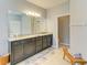 Bathroom featuring double vanity, stone countertop and tile floors at 15612 Trinity Fall Way, Bradenton, FL 34212