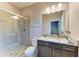Bathroom with a glass shower, granite countertop and light pink paint at 15612 Trinity Fall Way, Bradenton, FL 34212