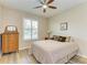 Bedroom with wood floors, ceiling fan, and lots of light at 15612 Trinity Fall Way, Bradenton, FL 34212