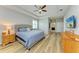 Bedroom with wood floors, tray ceilings and view of ensuite bathroom at 15612 Trinity Fall Way, Bradenton, FL 34212