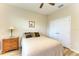 Bedroom featuring wood floors, ceiling fan, and closet at 15612 Trinity Fall Way, Bradenton, FL 34212