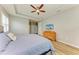 Bedroom features wood floors, ceiling fan, and door to outside at 15612 Trinity Fall Way, Bradenton, FL 34212