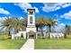 Inviting community entrance with a decorative tower, lush landscaping, and the 'Del Tierra' sign at 15612 Trinity Fall Way, Bradenton, FL 34212