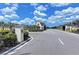 Community entrance with manicured landscaping and signage welcomes residents and visitors at 15612 Trinity Fall Way, Bradenton, FL 34212