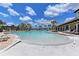 A spacious community pool features ample seating, palm trees, and a beautiful pool house with ample lounge chairs at 15612 Trinity Fall Way, Bradenton, FL 34212