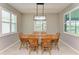 Charming dining room featuring a wooden table and chairs and lots of natural light at 15612 Trinity Fall Way, Bradenton, FL 34212