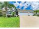 Lovely single-Gathering home with a three-car garage, beautiful landscaping, and lush green lawn at 15612 Trinity Fall Way, Bradenton, FL 34212