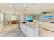 Modern kitchen featuring an island, granite countertops, stainless steel appliances, and open layout at 15612 Trinity Fall Way, Bradenton, FL 34212