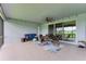 Covered outdoor patio area with ceiling fan and patio furniture that is perfect for entertaining at 15612 Trinity Fall Way, Bradenton, FL 34212