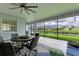 Relaxing screened patio with dining set offers water views and a ceiling fan for comfortable outdoor living at 15612 Trinity Fall Way, Bradenton, FL 34212